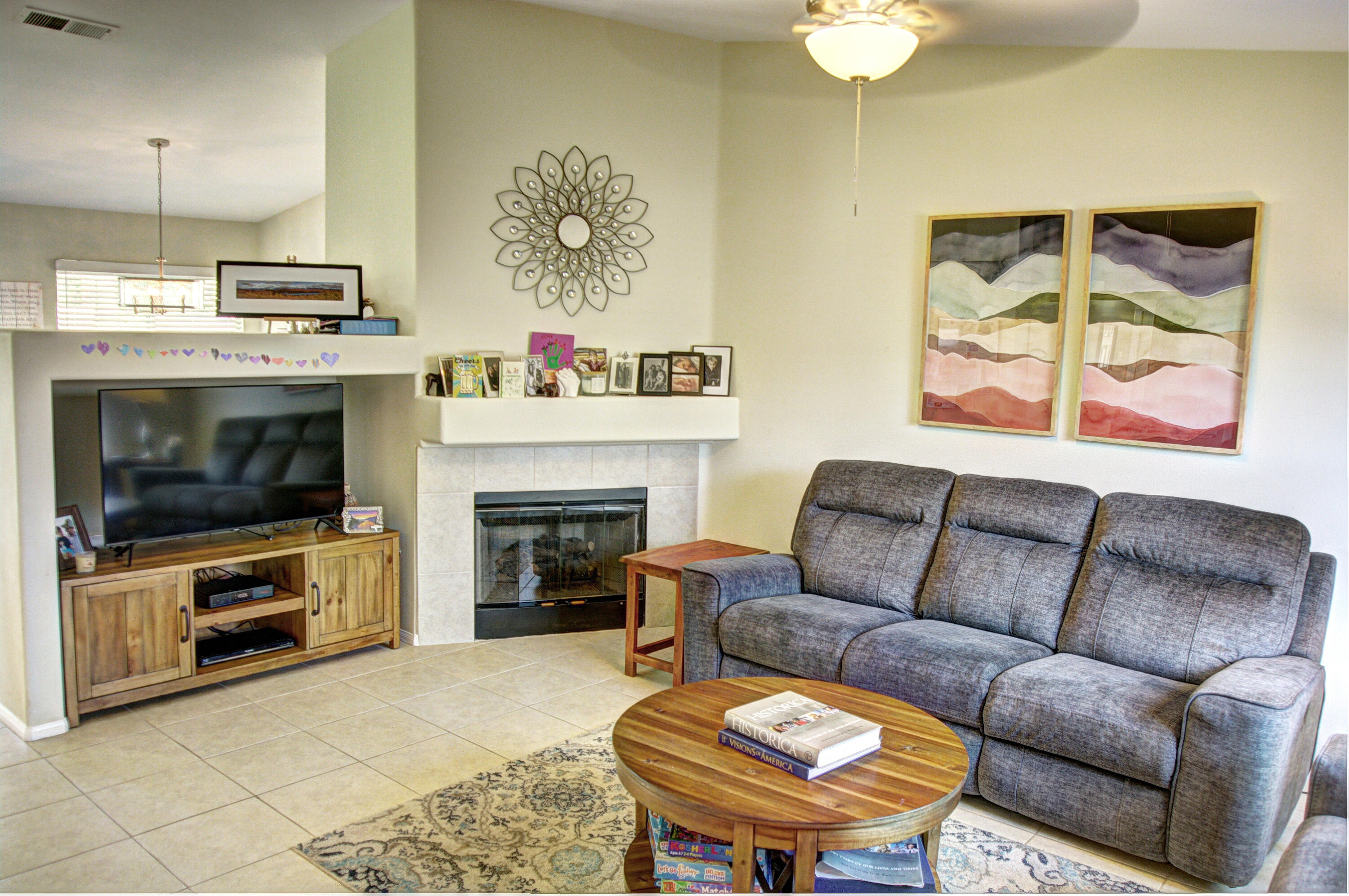 79379 Paseo Del Rey La Quinta, CA 92253 - Photo 3 of 24 a living room with furniture a flat screen tv and a fireplace