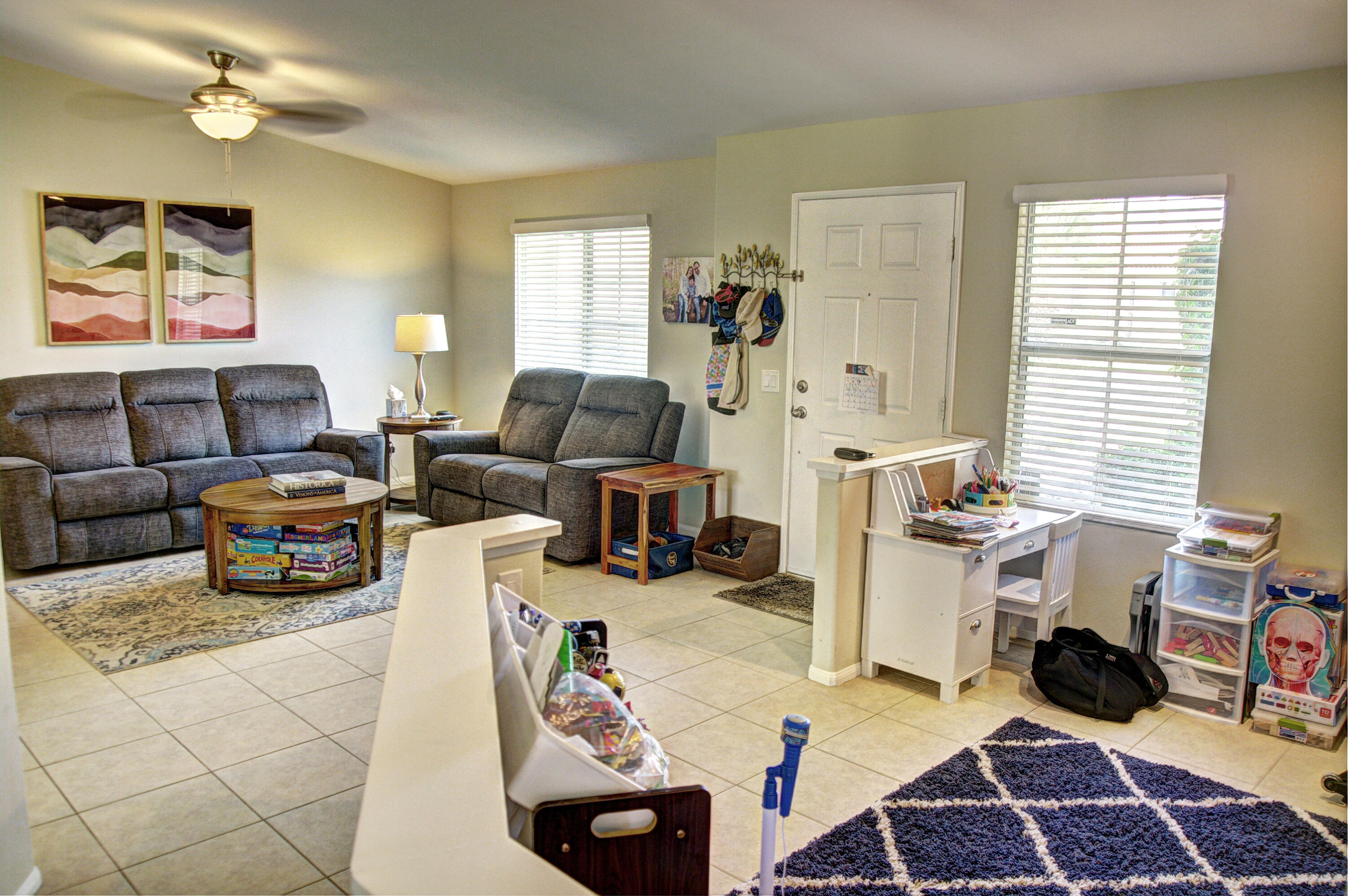 79379 Paseo Del Rey La Quinta, CA 92253 - Photo 5 of 24 a living room with furniture a large window and a chandelier