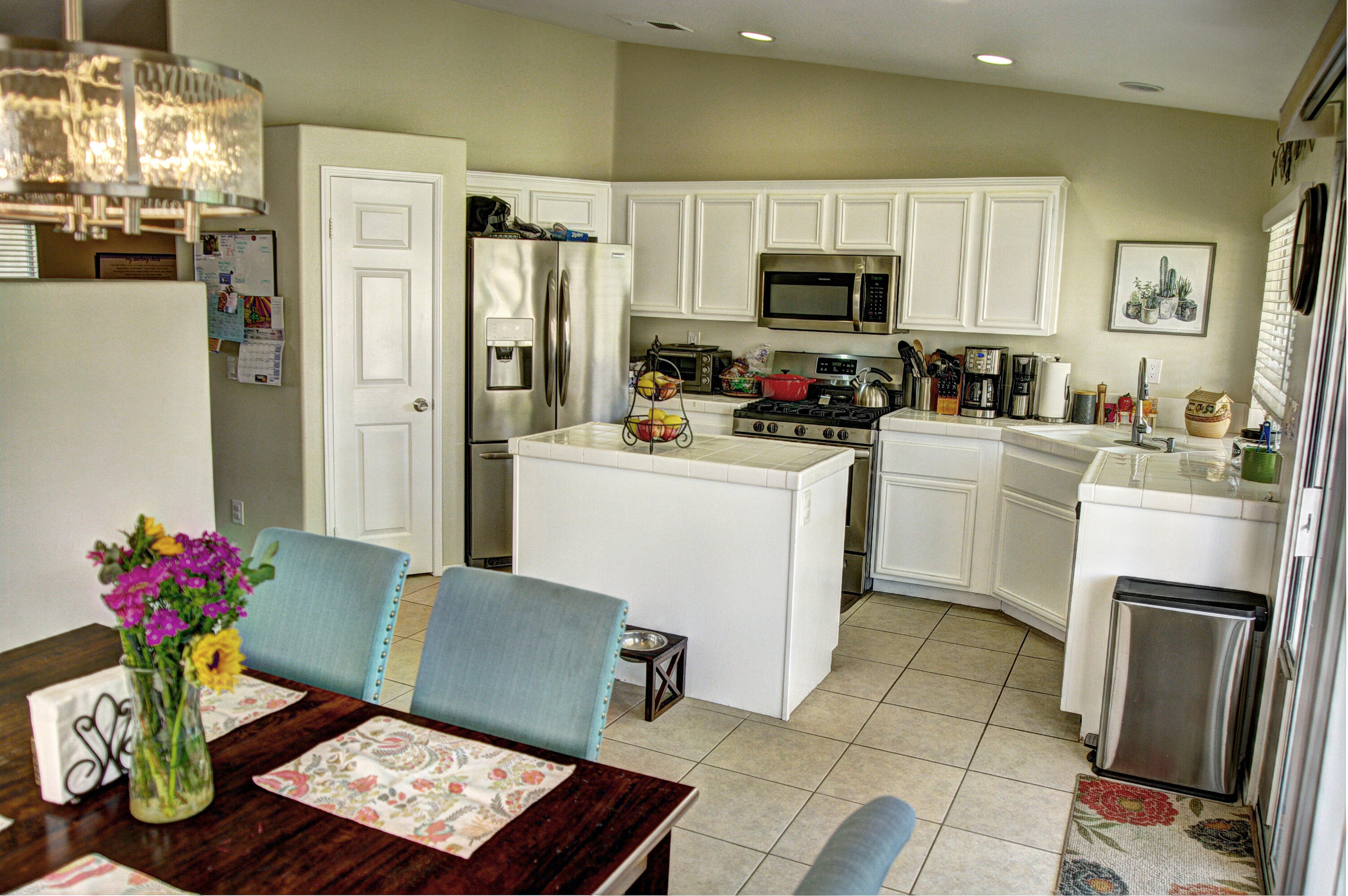 79379 Paseo Del Rey La Quinta, CA 92253 - Photo 8 of 24 a kitchen with stainless steel appliances a refrigerator sink microwave and cabinets