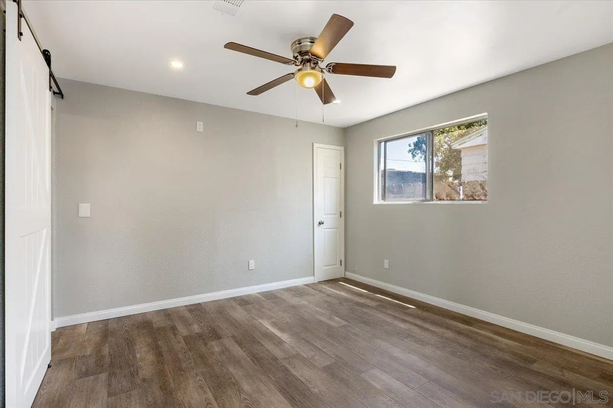 230 Zenith Street Chula Vista, CA 91911 - Photo 13 of 21 wooden floor in an empty room with a window