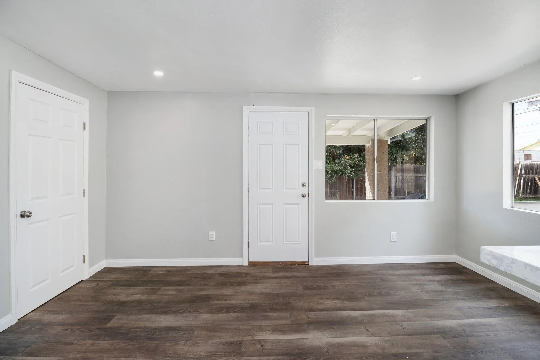 230 Zenith Street Chula Vista, CA 91911 - Photo 14 of 21 a view of an empty room with wooden floor and a window
