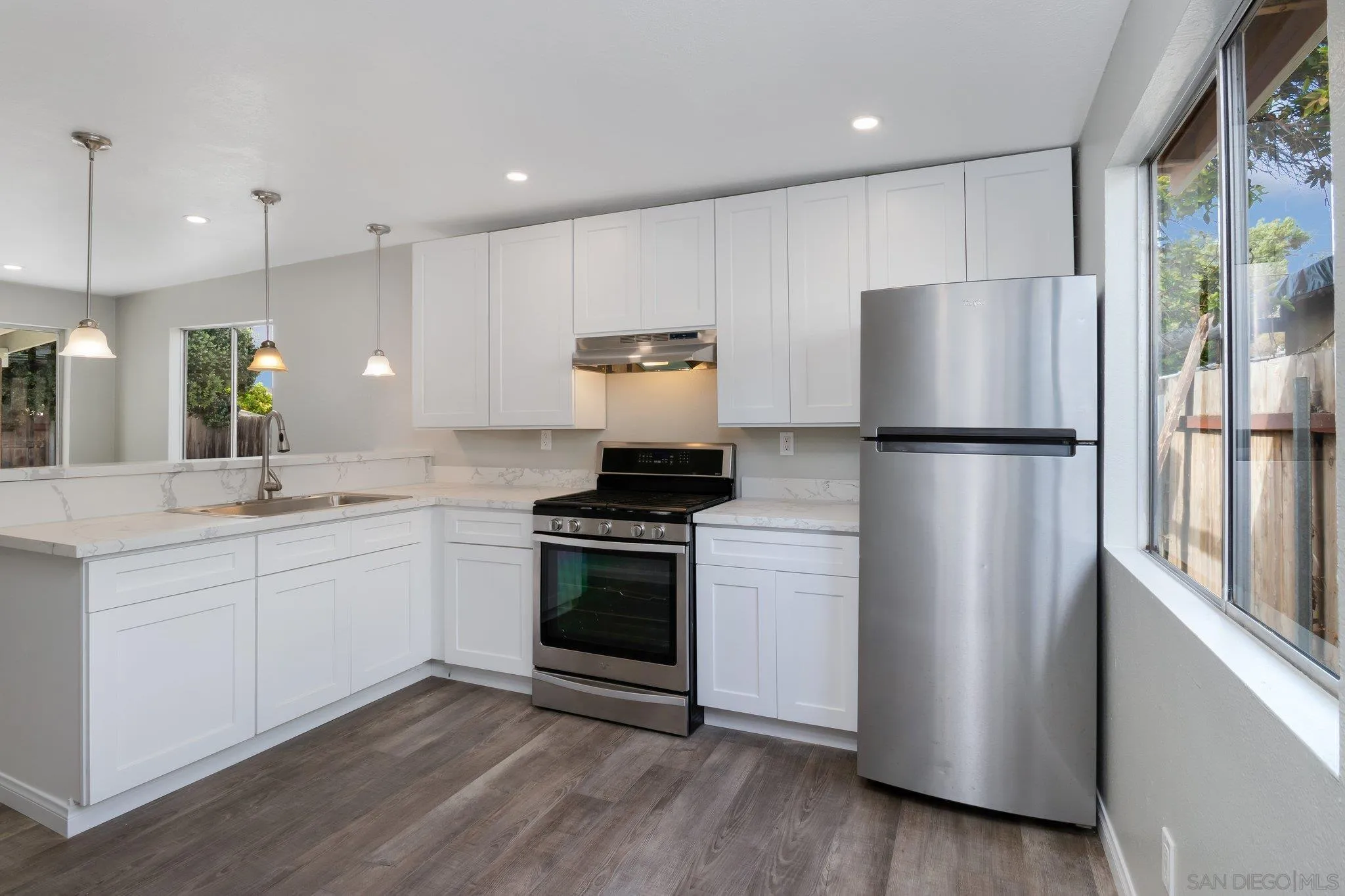 230 Zenith Street Chula Vista, CA 91911 - Photo 15 of 21 a kitchen with stainless steel appliances granite countertop a refrigerator a stove a sink and a microwave