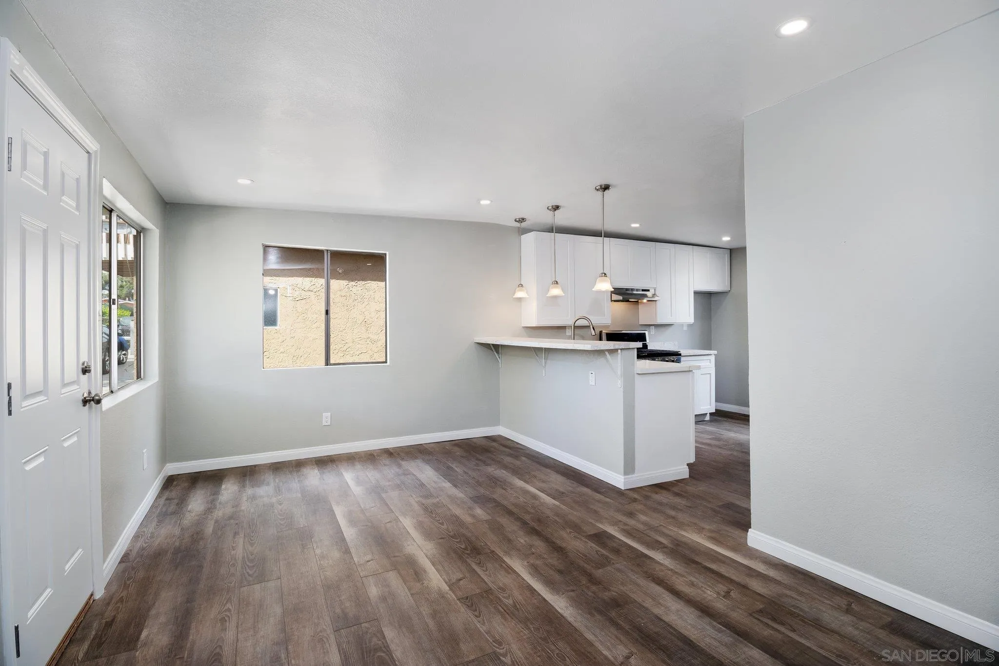 230 Zenith Street Chula Vista, CA 91911 - Photo 17 of 21 a kitchen with granite countertop white cabinets and wooden floor
