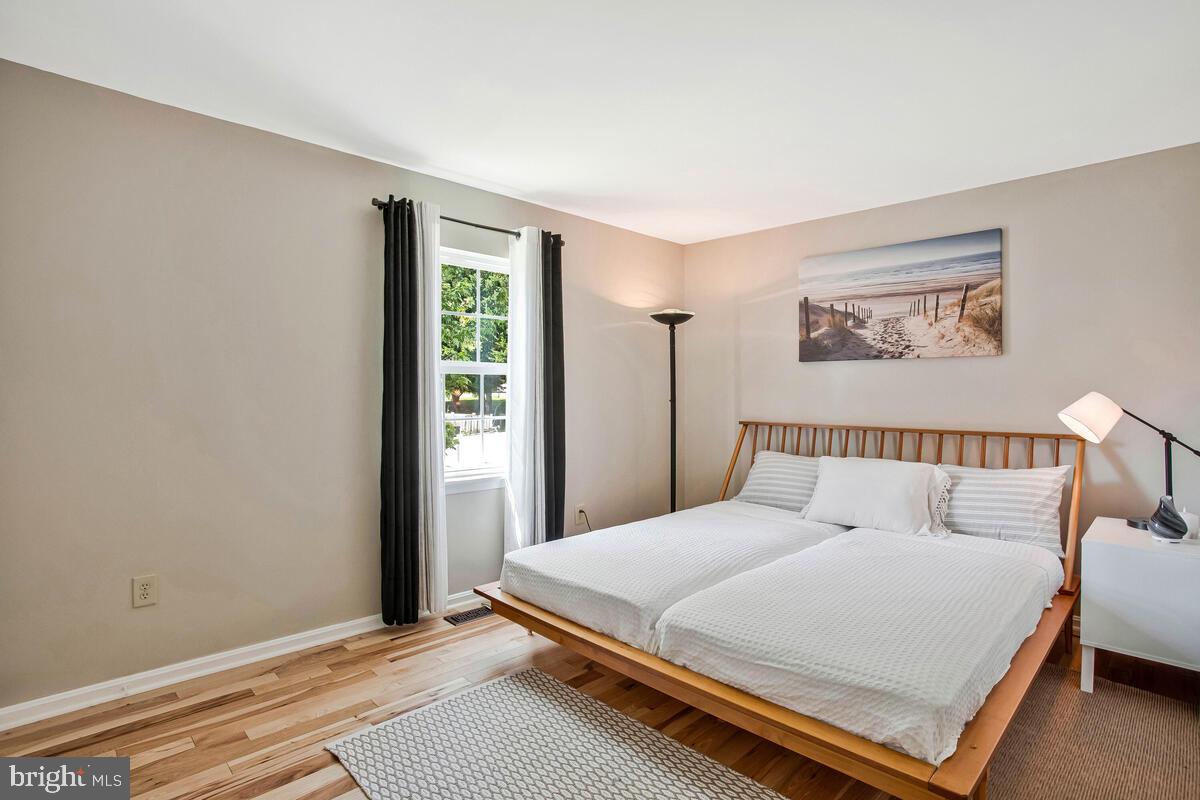 3709 29th Street Chesapeake Beach, MD 20732 - Photo 13 of 71 a large bed sitting in a bedroom next to a window