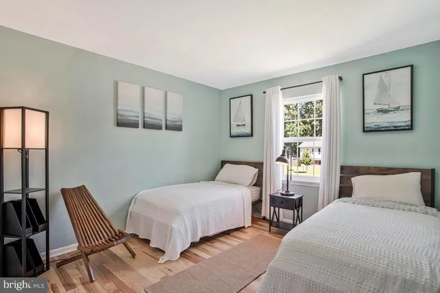a living room with furniture a flat screen tv and a window