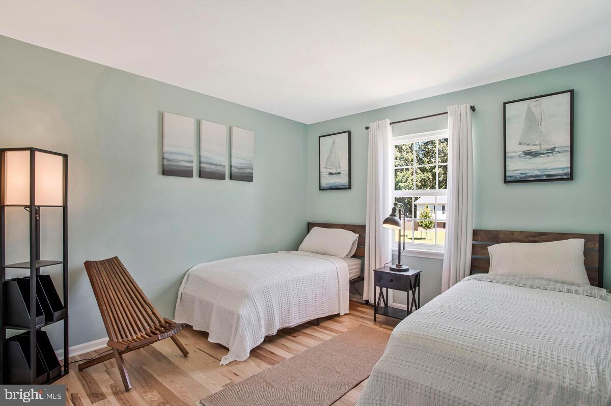 3709 29th Street Chesapeake Beach, MD 20732 - Photo 17 of 71 a bedroom with a bed and a large window