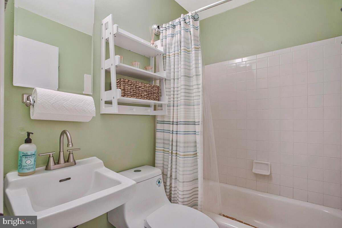 3709 29th Street Chesapeake Beach, MD 20732 - Photo 18 of 71 a bathroom with a sink toilet and shower