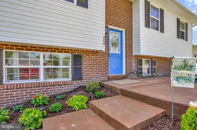 a view of a house with a small yard and a potted plant