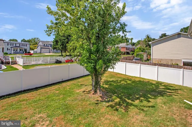 a white house with a yard and trees