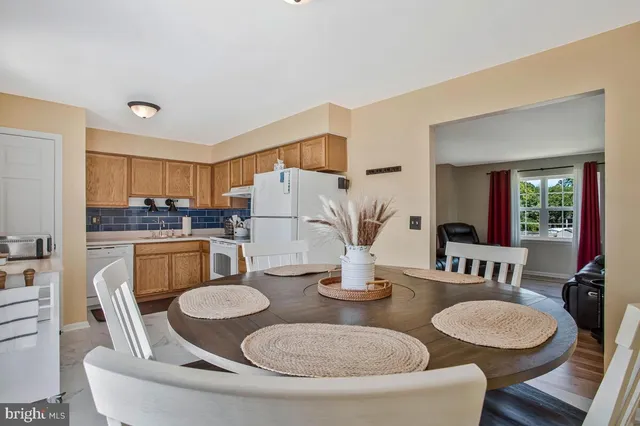 a kitchen with a table and chairs
