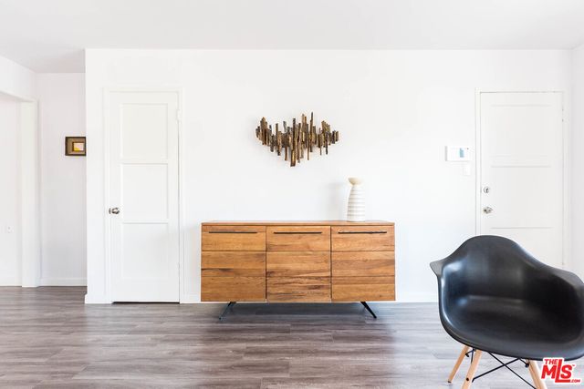 a living room with furniture wooden floor and a rug