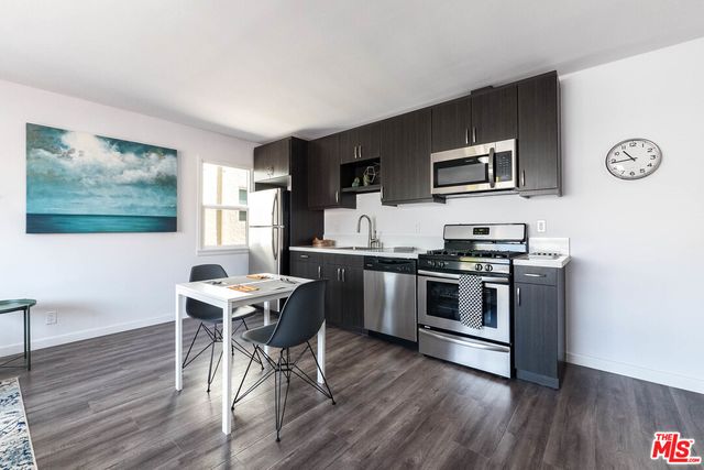 a spacious bedroom with a bed and a window