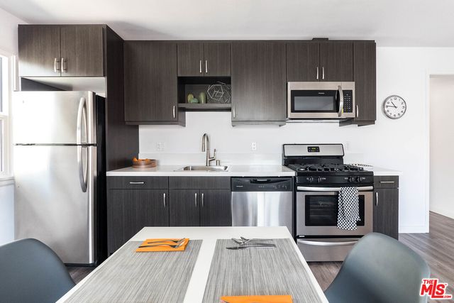 a view of a livingroom with a chair and a potted plant