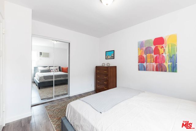 a white wall with a painting on it