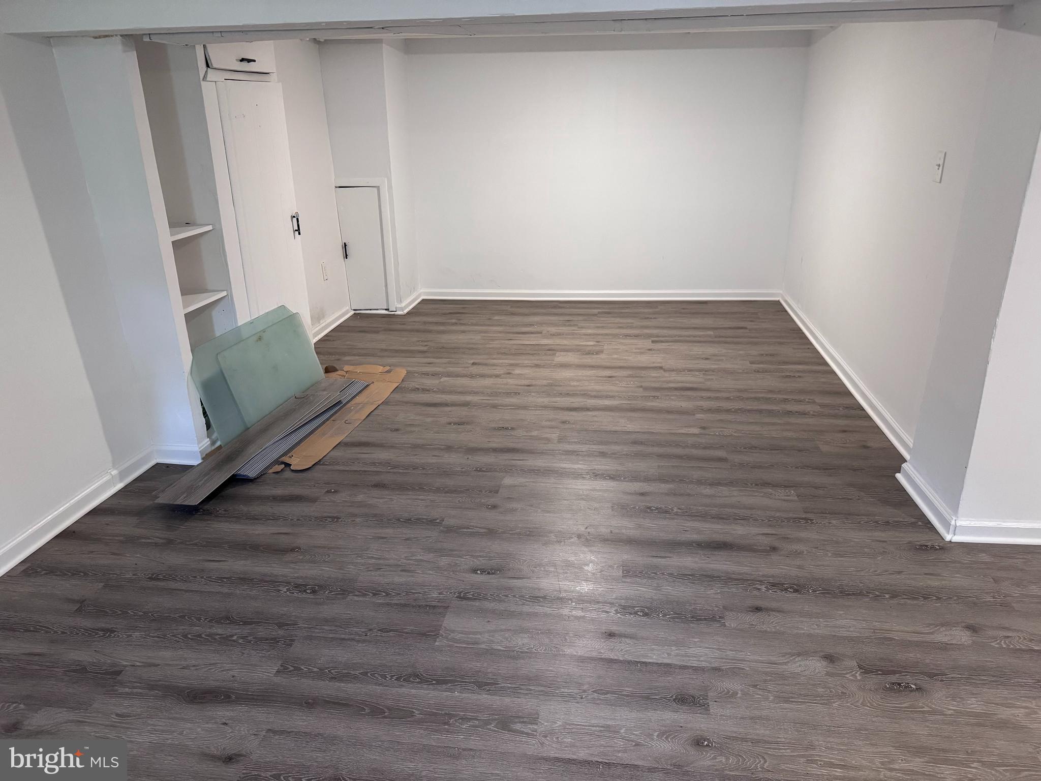 222 Townsend Avenue Baltimore, MD 21225 - Photo 15 of 24 a view of a room with wooden floor and white walls