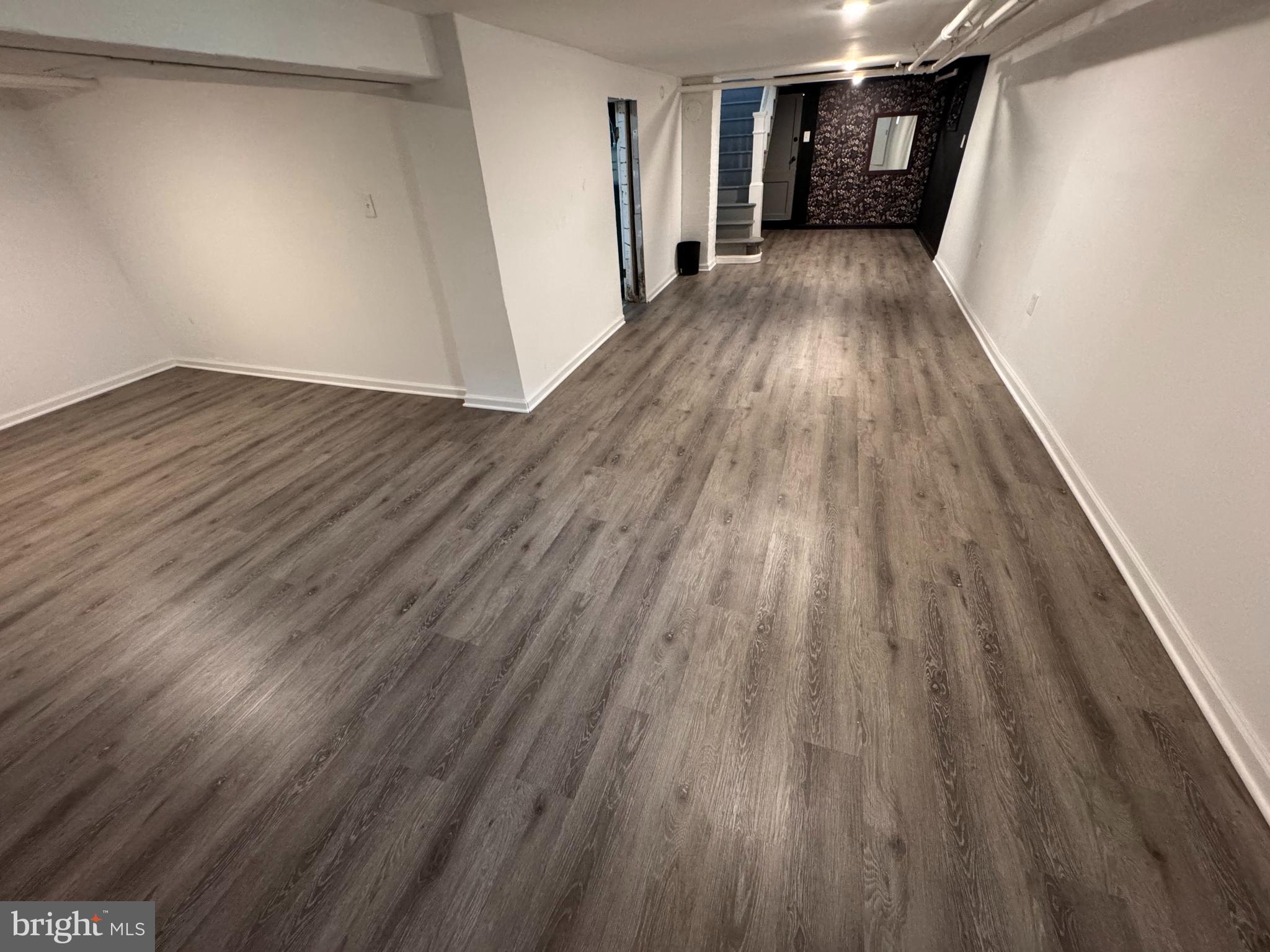 222 Townsend Avenue Baltimore, MD 21225 - Photo 16 of 24 a view of a hallway with wooden floor