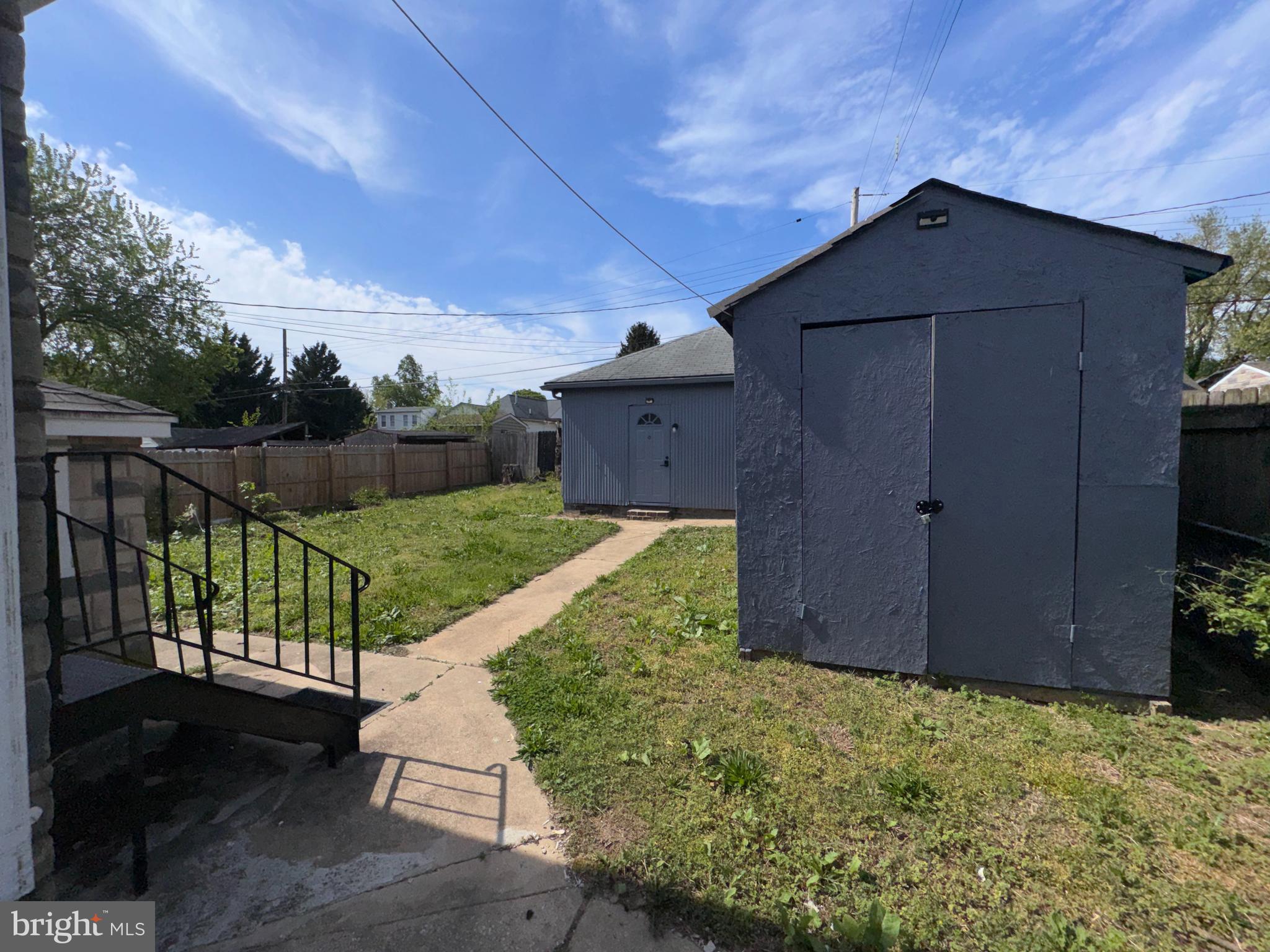 222 Townsend Avenue Baltimore, MD 21225 - Photo 20 of 24 a wooden bench sitting in front of a house