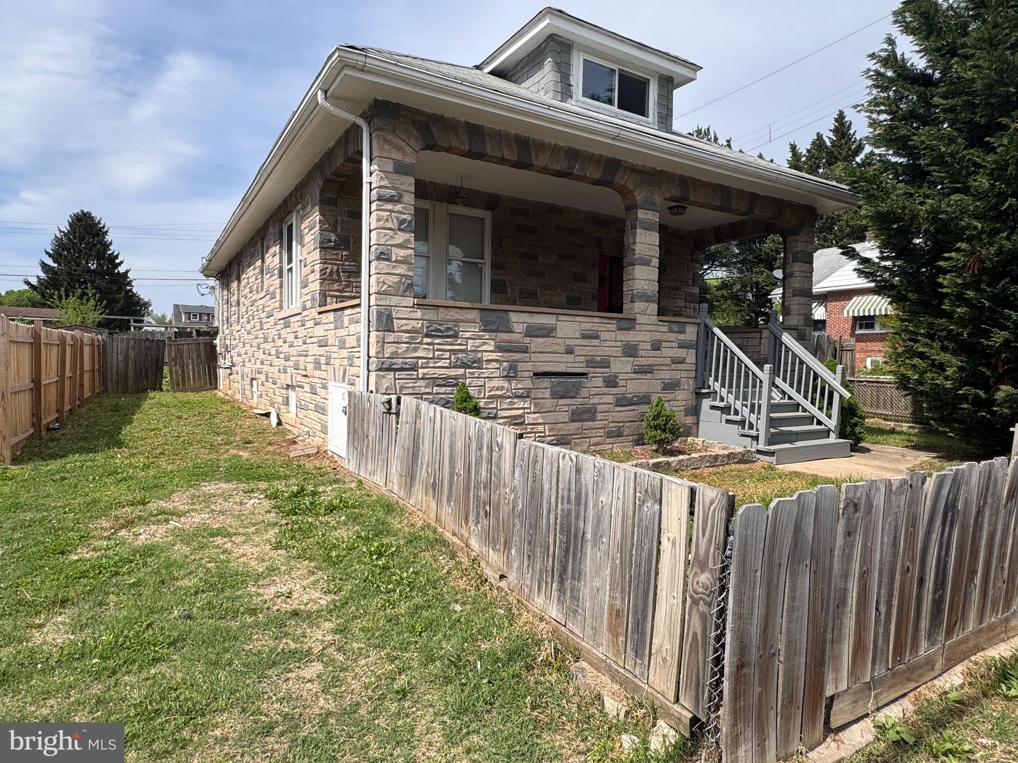222 Townsend Avenue Baltimore, MD 21225 - Photo 2 of 24 a front view of house with wooden fence