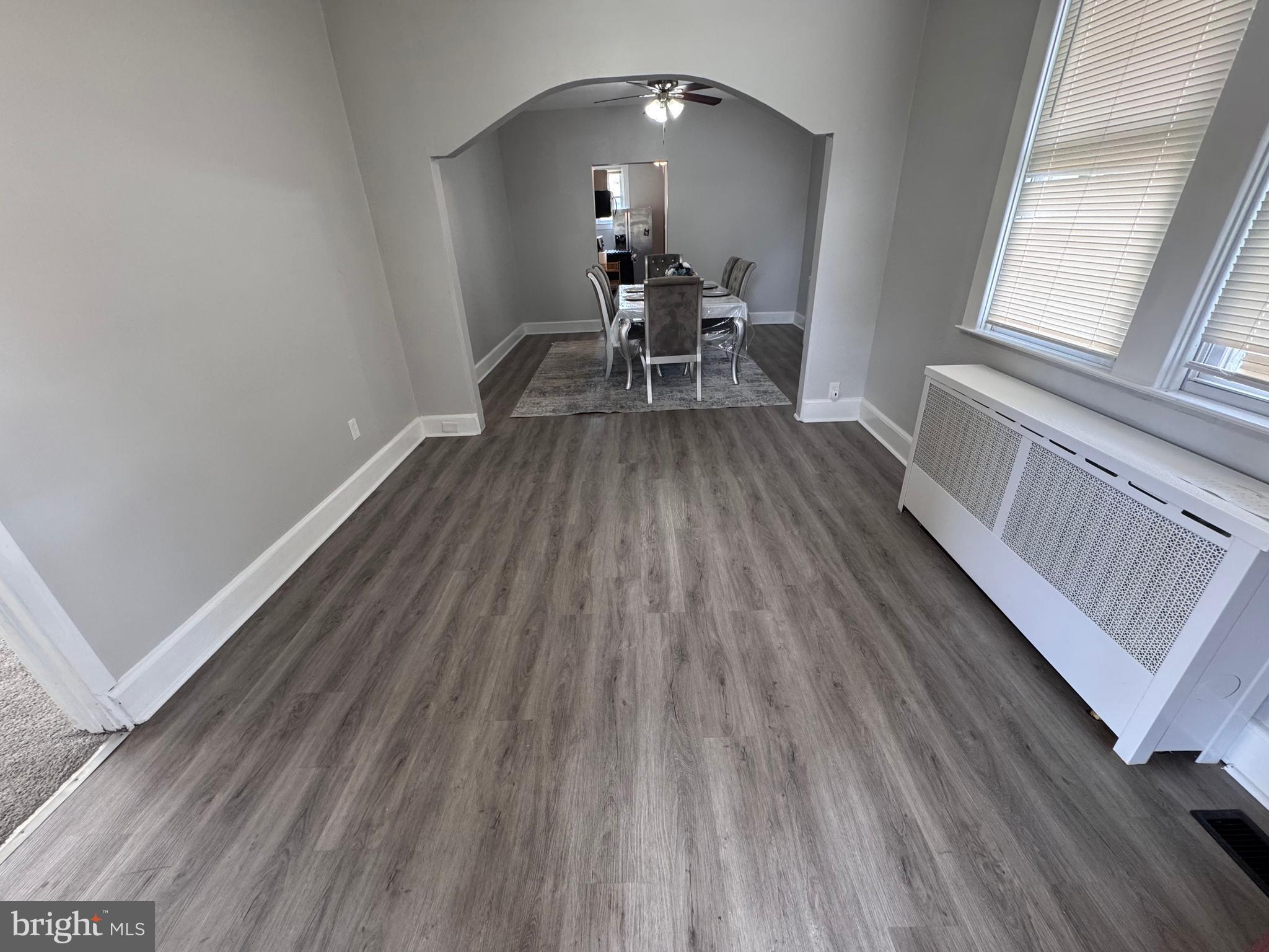 222 Townsend Avenue Baltimore, MD 21225 - Photo 4 of 24 a view of a room with wooden floor table and chairs