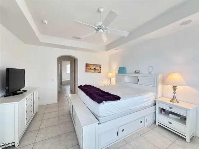 a bedroom with a bed and a large window with the outer view