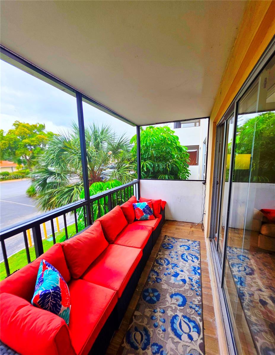 4164 Inverrary Drive, Unit 204 Lauderhill, FL 33319 - Photo 20 of 28 a balcony with furniture and wooden floor