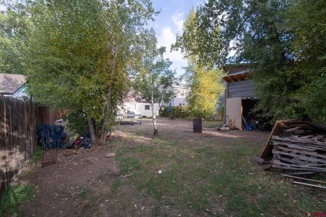 a view of a patio with a table and chairs next to a yard