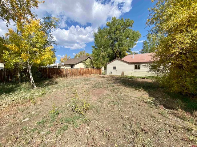 a backyard of a house with lots of green space