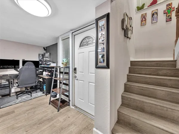 a kitchen with stainless steel appliances granite countertop a refrigerator a stove top oven and a sink