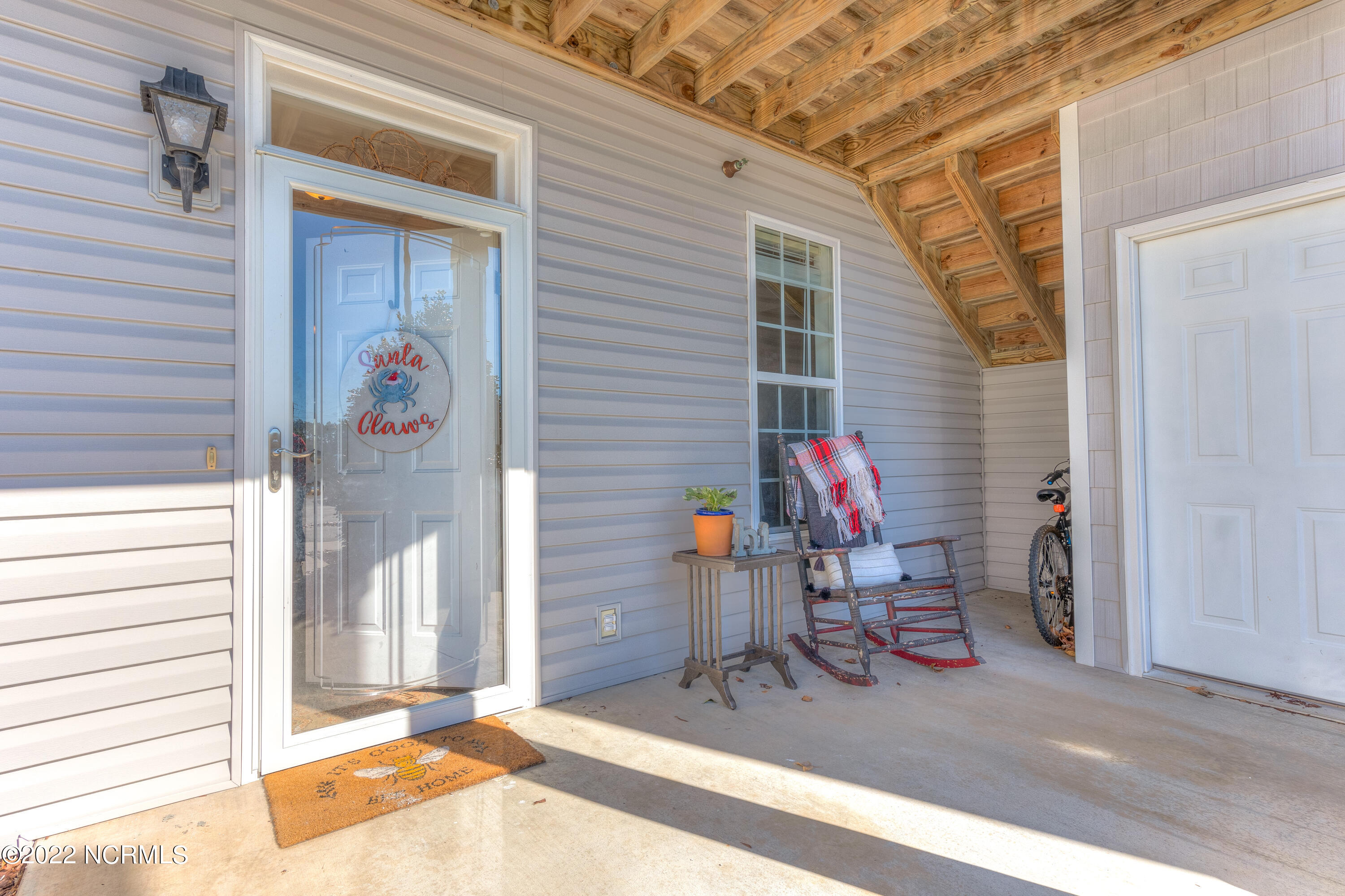 175 Old Murdoch Road, Unit 103 Morehead City, NC 28570 - Photo 2 of 22 Front door, storage, patio