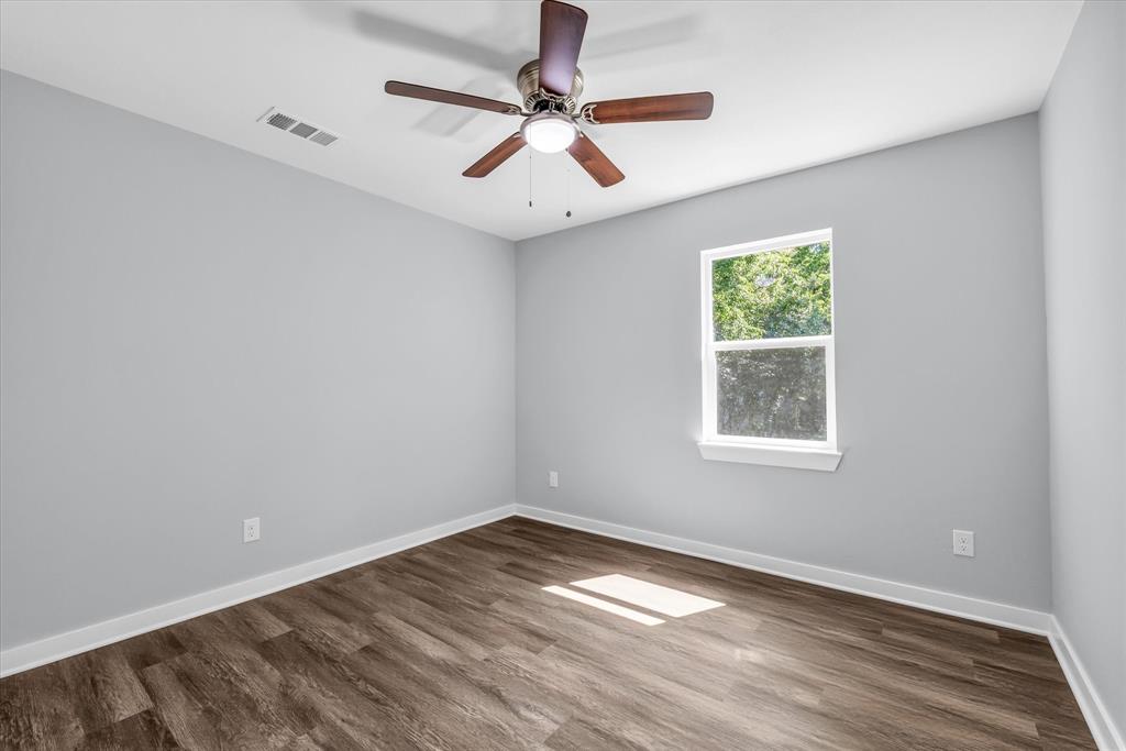 3608 North 26th Street Waco, TX 76708 - Photo 20 of 28 a view of empty room with wooden floor and fan