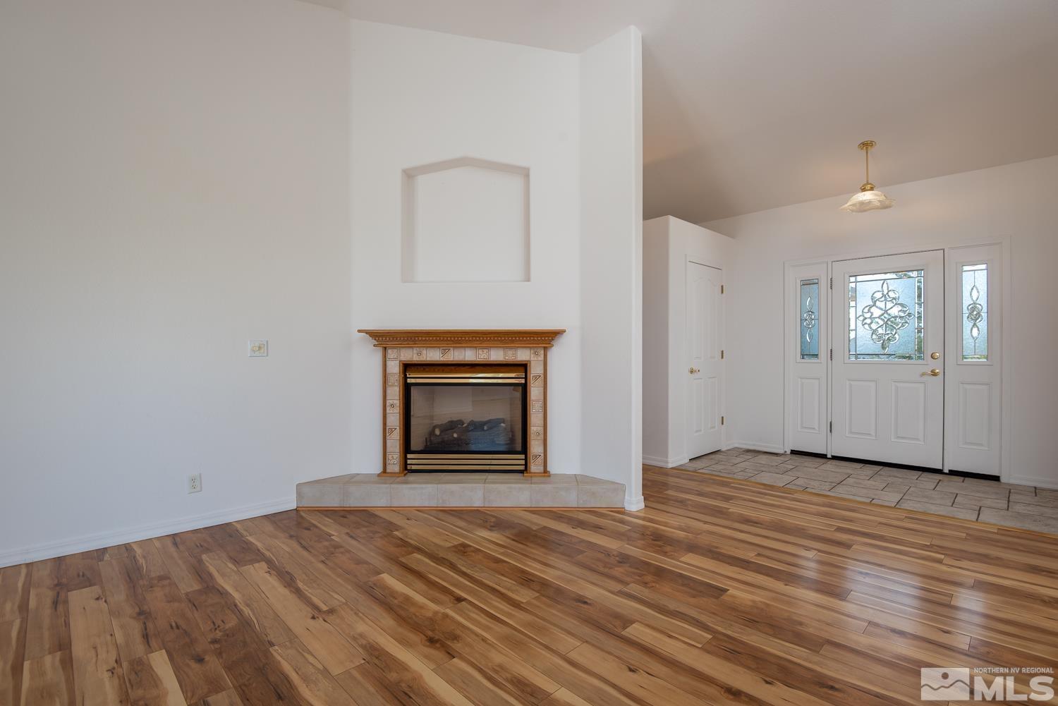 2876 Jackie Circle Minden, NV 89423 - Photo 13 of 40 an empty room with windows and fireplace