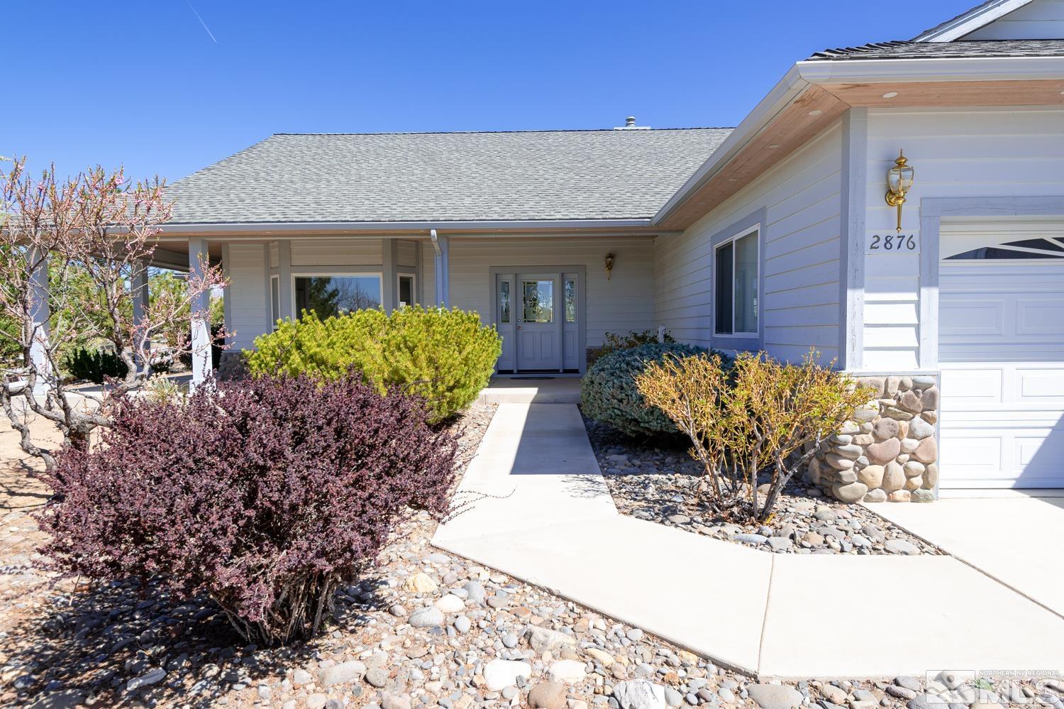 2876 Jackie Circle Minden, NV 89423 - Photo 2 of 40 a view of a house with potted plants