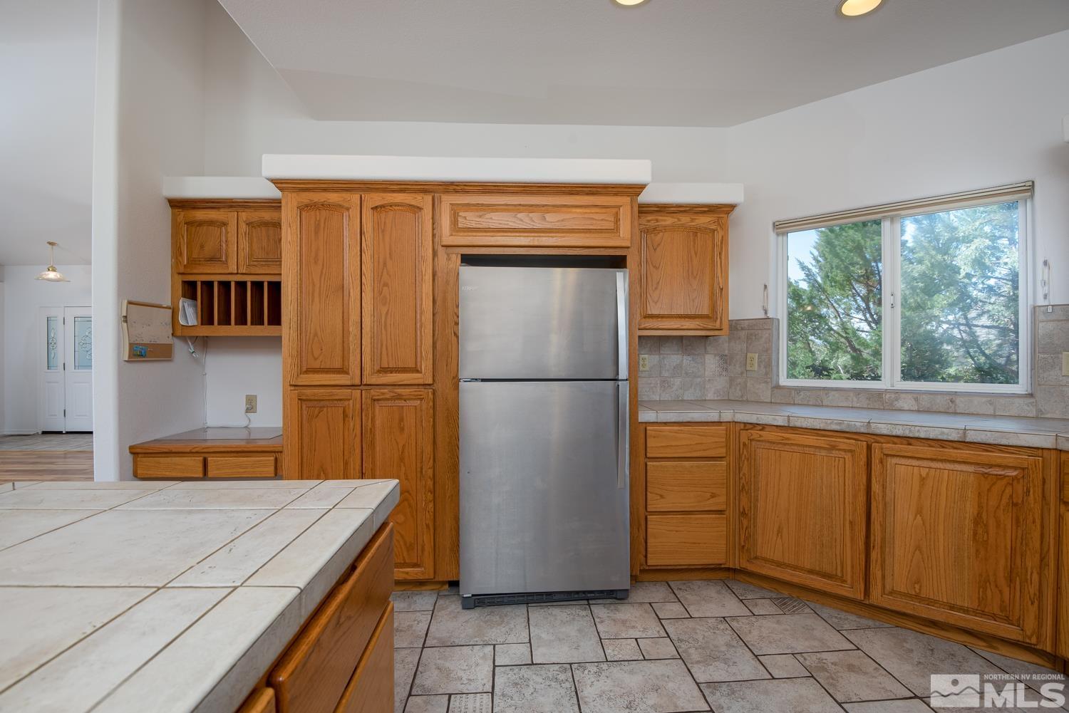 2876 Jackie Circle Minden, NV 89423 - Photo 10 of 40 a kitchen with stainless steel appliances granite countertop a refrigerator sink and cabinets