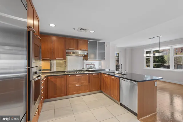 a kitchen with stainless steel appliances granite countertop a refrigerator and a sink