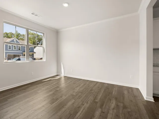 a kitchen with stainless steel appliances a stove top oven a sink a refrigerator white cabinets and wooden floor