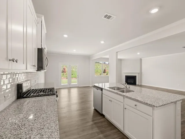 a kitchen with granite countertop cabinets stainless steel appliances and a counter top space