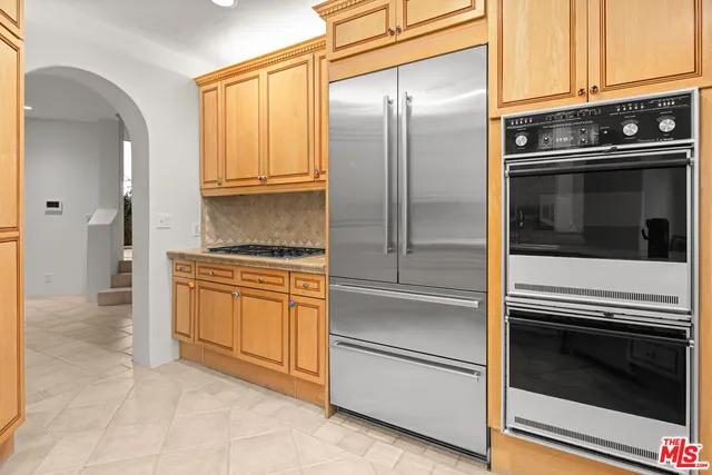 a kitchen with granite countertop stainless steel appliances and cabinets