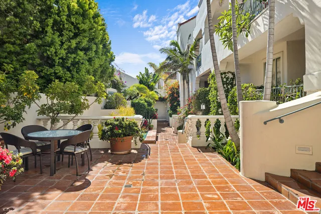 a view of a patio with table and chairs and potted plants