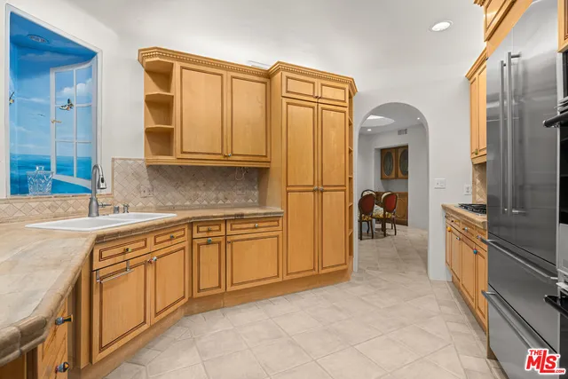 a spacious bathroom with a granite countertop sink mirror and a bathtub