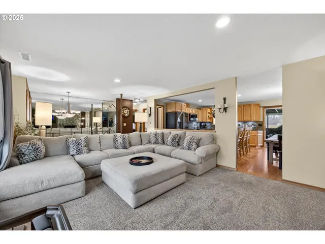 a living room with furniture and view of kitchen