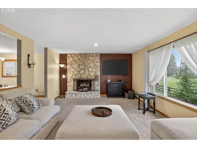 a living room with furniture a fireplace and a flat screen tv