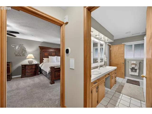a en suite bathroom with a double vanity sink a mirror and a bathtub