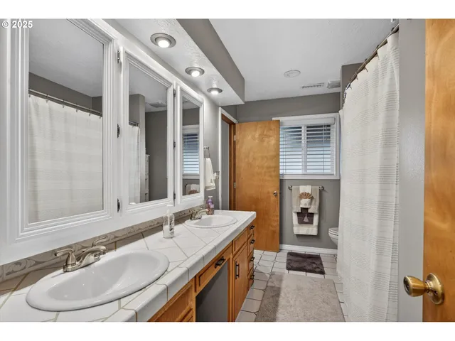 a bathroom with a sink double vanity and a mirror