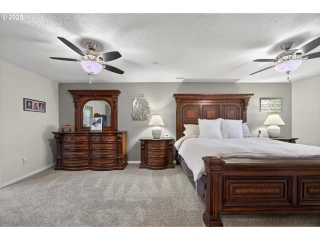 a bedroom with bed and wooden floor