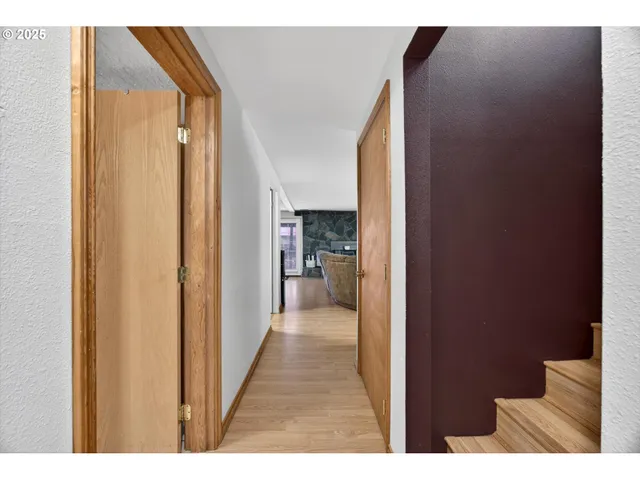 a view of a hallway with wooden shelves