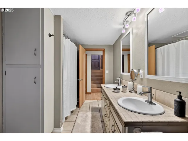 a bathroom with a sink double vanity and a mirror