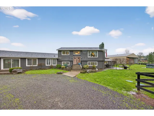 a view of an house with backyard space and balcony