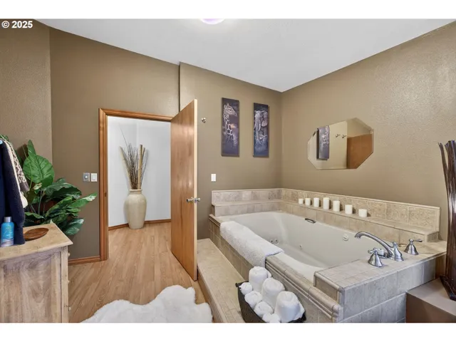a bathroom with a tub sink and mirror