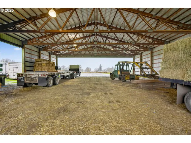 a living room with lots of furniture and a kitchen view