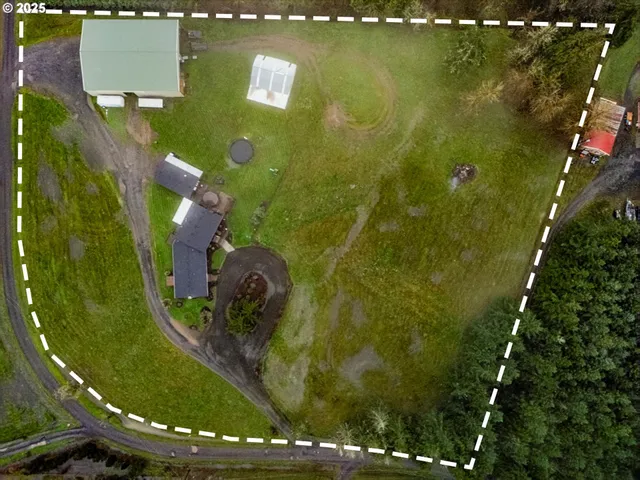 an aerial view of a residential houses with swimming pool and outdoor space